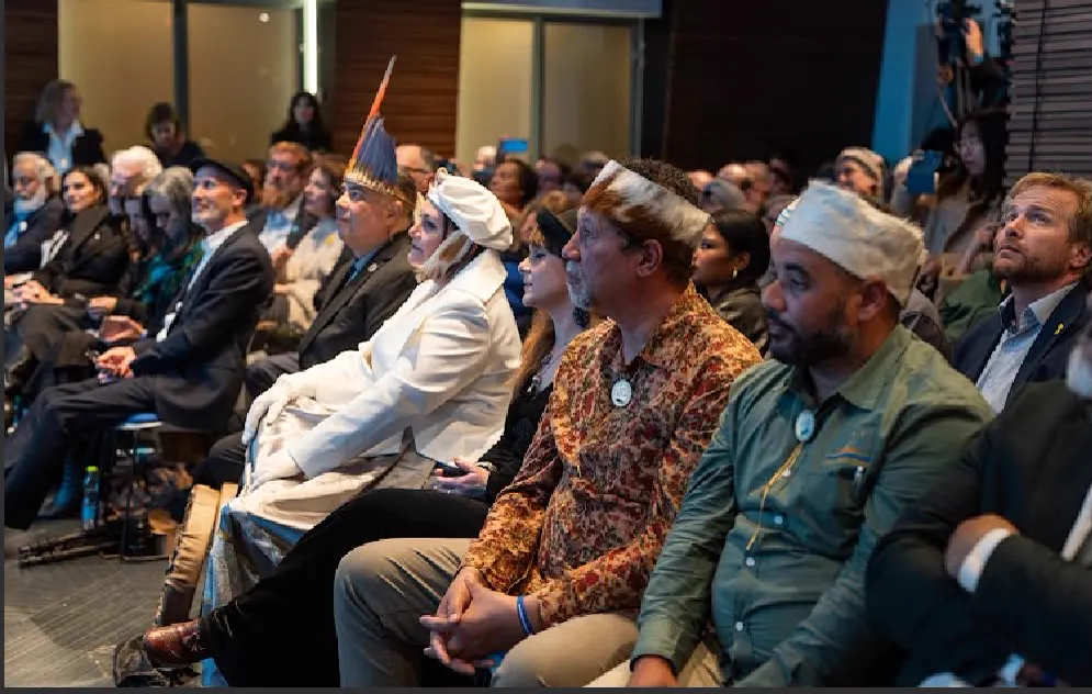 Attendees seated together at an indoor event