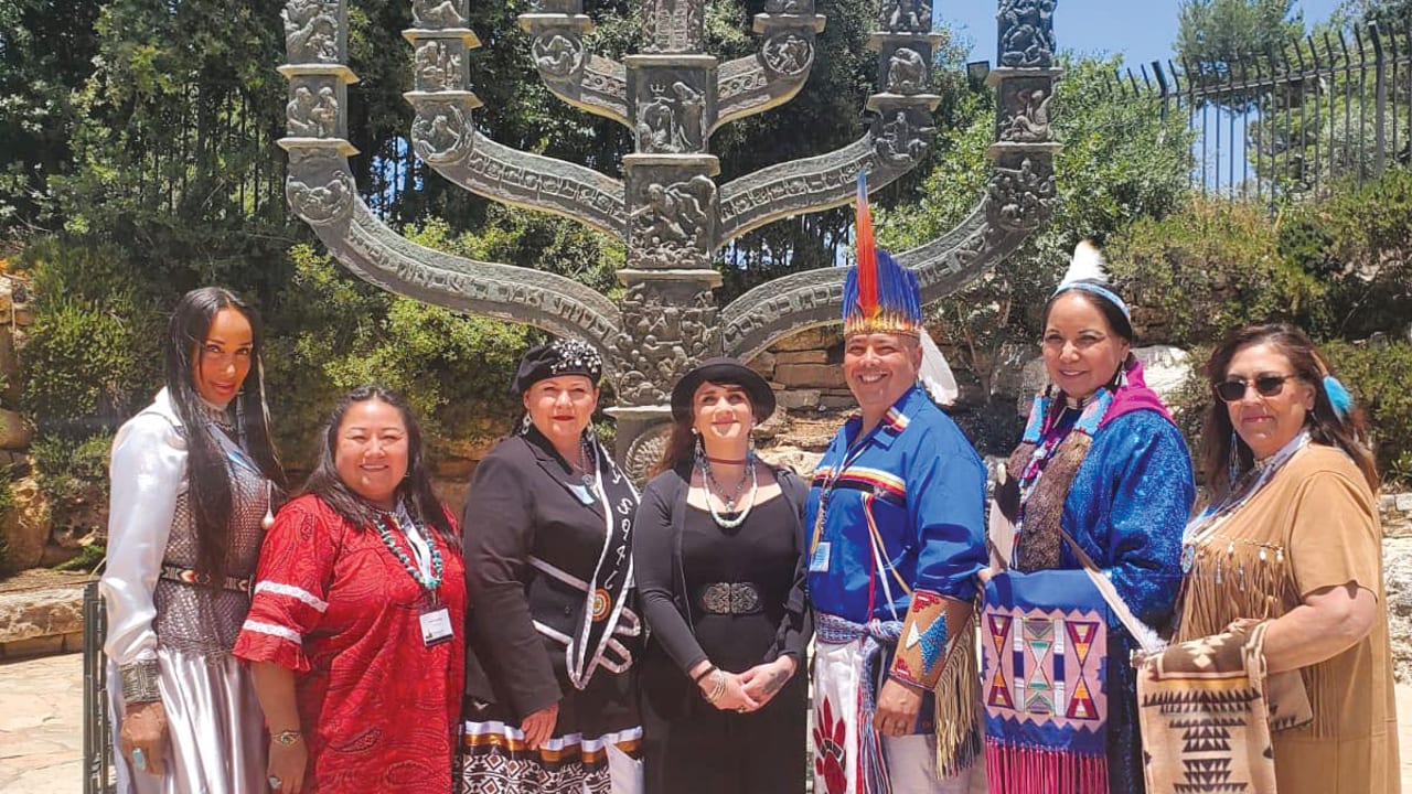 Ateret Shmuel with Native American chiefs outside the Knesset in Jerusalem, standing in front of the Knesset Menorah.